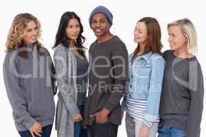 Fashionable young people in a row all looking at man