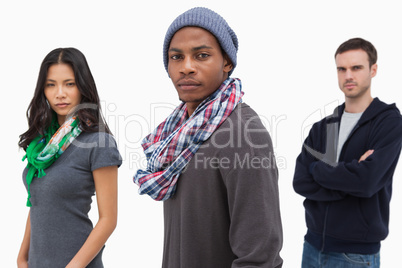 Unsmiling stylish young people in a row