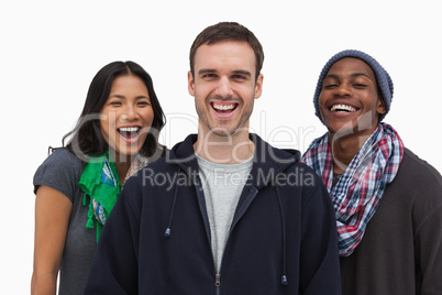 Stylish young friends laughing at camera