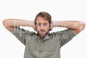 Man blocking his ears and closing his eyes