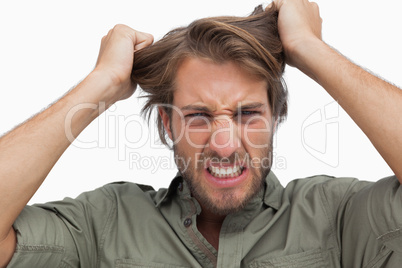 Furious man pulling his hair