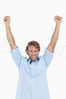 Happy man celebrating success with arms up