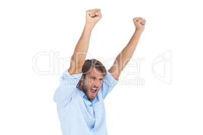 Smiling man celebrating success with arms up