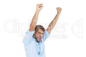 Smiling man celebrating success with arms up