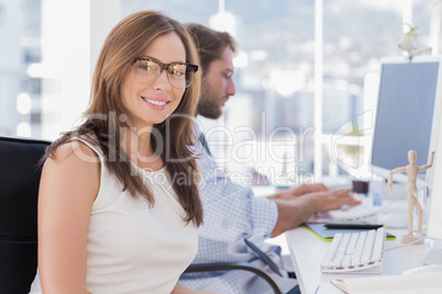 Pretty designer smiling at camera Pretty designer smiling at camera