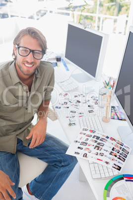 Photo editor looking up from his work and smiling