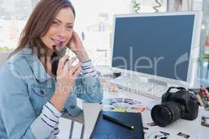 Photo editor looking thoughtful at her desk