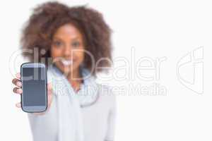 Woman with afro showing her smartphone