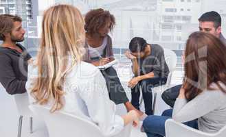 Group therapy session with one woman crying