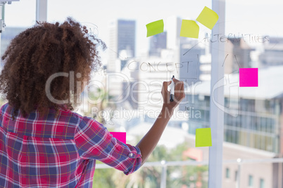 Woman drawing on flowchart with sticky notes Woman drawing on flowchart with sticky notes