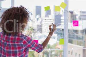 Woman drawing on flowchart with sticky notes