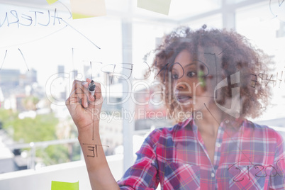 Woman drawing on flowchart with marker