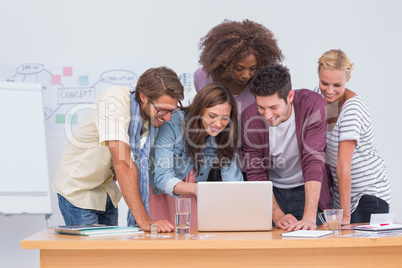 Creative team looking at laptop