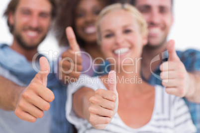 Happy fashionable group giving thumbs up