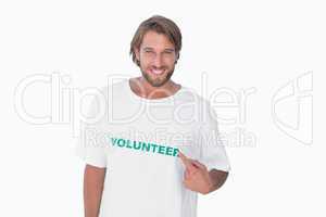 Smiling man pointing to his volunteer tshirt