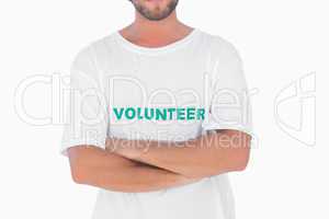 Man wearing volunteer tshirt with arms crossed