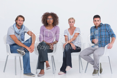 Stylish people sitting and looking at camera