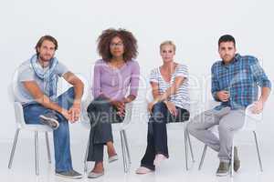 Stylish people sitting and looking at camera