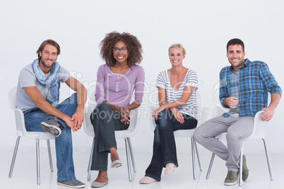 Stylish people sitting and smiling at camera