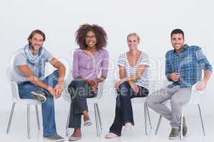 Stylish people sitting and smiling at camera