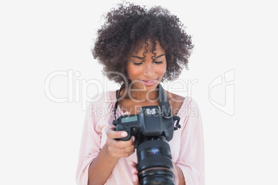 Happy woman looking at digital camera