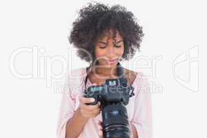 Happy woman looking at digital camera