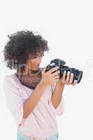 Smiling woman looking through digital camera