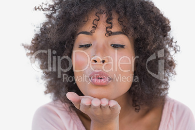 Happy woman blowing a kiss