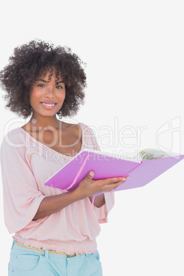 Beautiful woman holding photo album and smiling