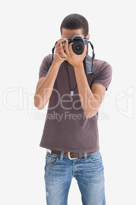 Hip young man pointing his camera at the camera