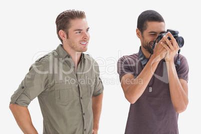 Stylish man watching his friend taking a picture