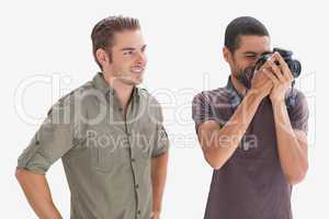 Stylish man watching his friend taking a picture