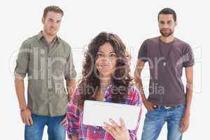 Stylish friends looking at camera with one holding tablet