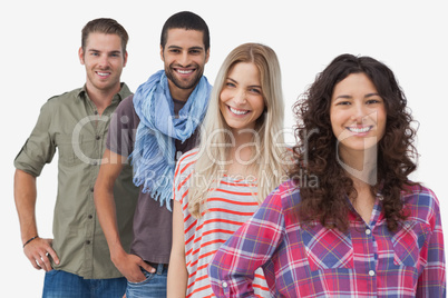 Four fashionable friends smiling at camera