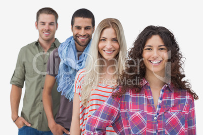 Four fashionable friends looking at camera