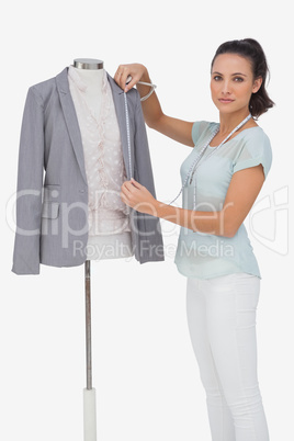 Fashion designer measuring blazer