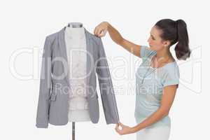 Fashion designer measuring blazer sleeve