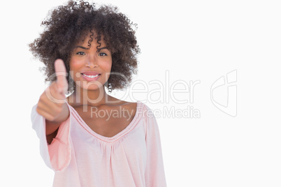 Woman giving thumbs up to camera