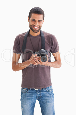 Happy man with camera around his neck