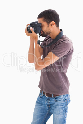 Stylish man taking photograph with digital camera