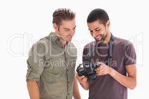 Stylish men looking at digital camera