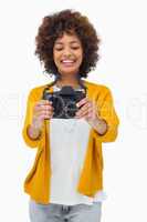 Happy girl holding digital camera