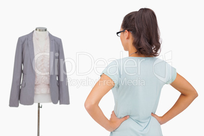 Designer looking at her mannequin