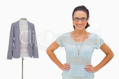 Happy designer looking at camera with hands on hips