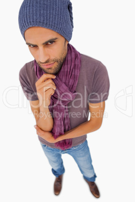 Thinking man wearing beanie hat and scarf