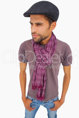 Thougthful man wearing peaked cap and scarf