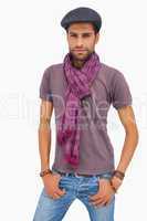 Serious man wearing peaked cap and scarf
