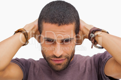 Handsome man posing with hands on head