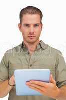Serious man using tablet pc