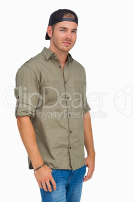 Man smiling and wearing baseball hat backwards